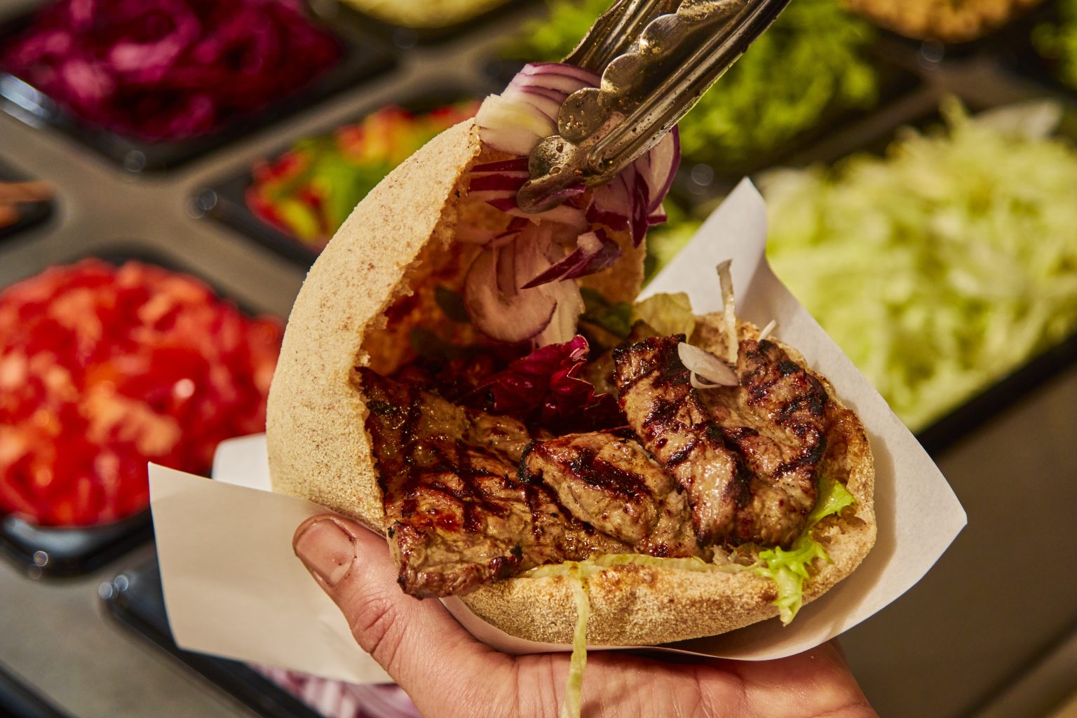 Freshly baked Urban Pitta filled with grilled meat and colourful salad