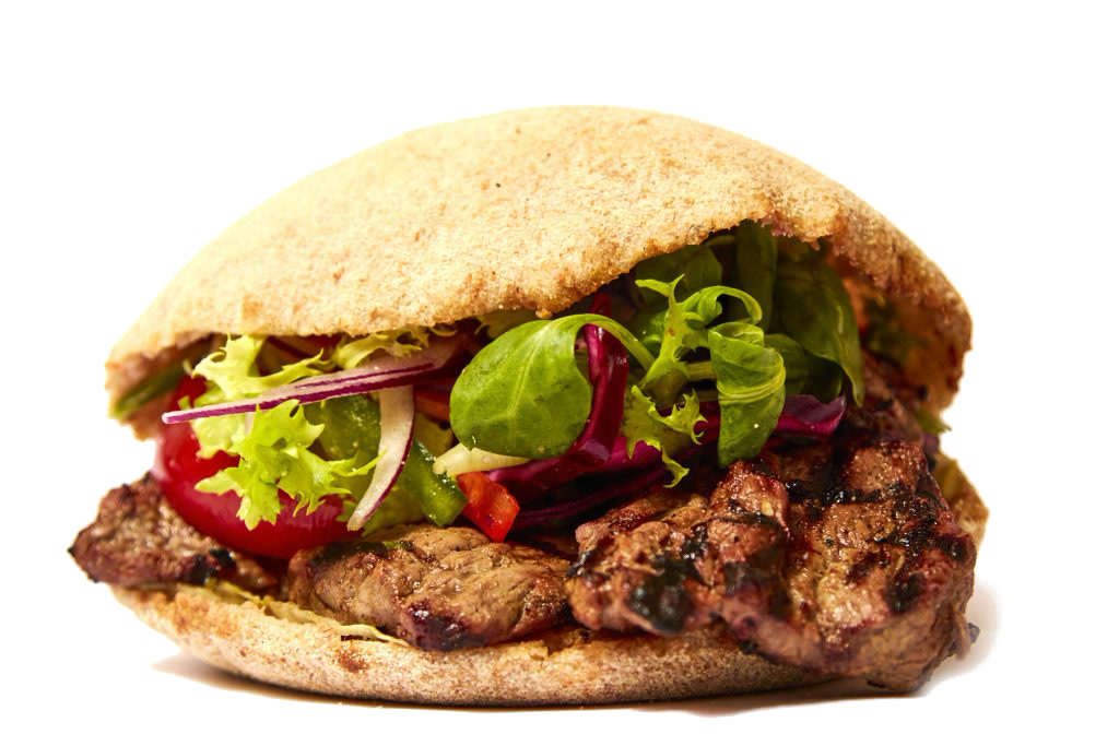 A stone baked pitta filled with grilled meat and fresh salad