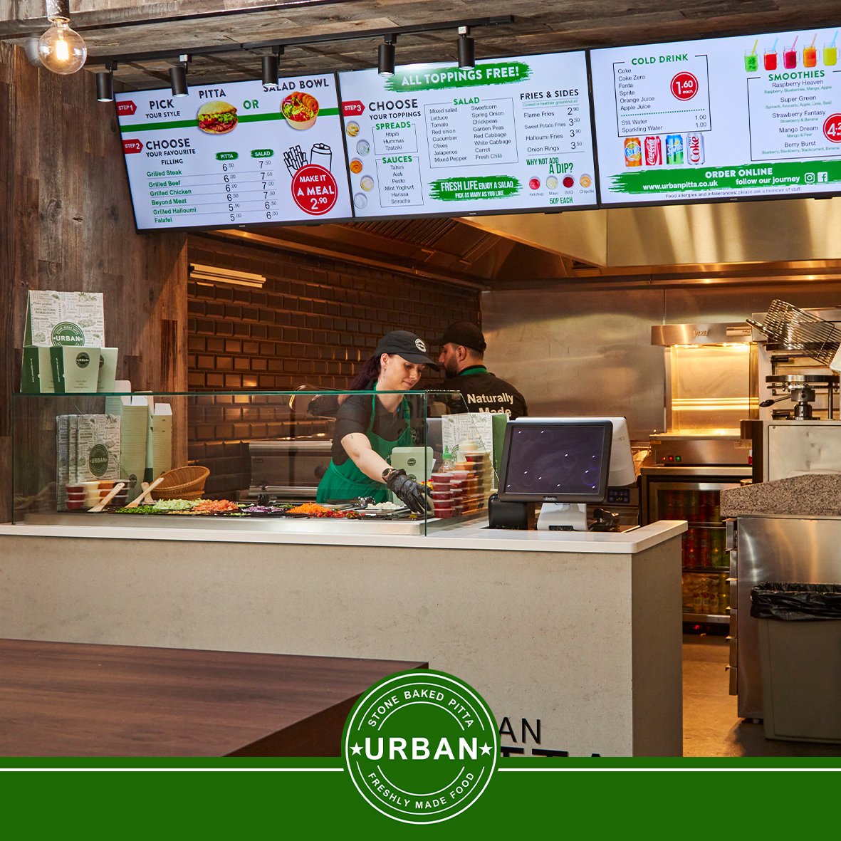 The Urban Pitta team preparing food behind the counter